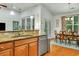 Open kitchen area with granite countertops, stainless steel appliances, and a view to the dining room at 199 Gilman Rd., Pawleys Island, SC 29585
