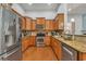 Well-equipped kitchen with stainless steel appliances, wooden cabinetry, and granite countertops at 199 Gilman Rd., Pawleys Island, SC 29585