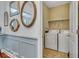 Well-equipped laundry room with washer and dryer hookups, shelving, and tile flooring at 199 Gilman Rd., Pawleys Island, SC 29585