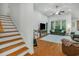 Bright living room featuring hardwood floors, comfortable seating, and a staircase leading to the upper level at 199 Gilman Rd., Pawleys Island, SC 29585