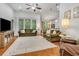 Spacious living room with hardwood floors, a ceiling fan, and a view to the breakfast bar and kitchen at 199 Gilman Rd., Pawleys Island, SC 29585