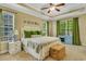 Bright main bedroom featuring a tray ceiling, ceiling fan, and lots of natural light at 199 Gilman Rd., Pawleys Island, SC 29585