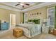 Bright main bedroom featuring a tray ceiling, ceiling fan, and lots of natural light at 199 Gilman Rd., Pawleys Island, SC 29585