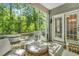 Cozy screened porch featuring wicker furniture and views of the serene outdoors at 199 Gilman Rd., Pawleys Island, SC 29585