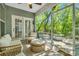 Relaxing screened porch with wicker furniture and a view of the lush backyard at 199 Gilman Rd., Pawleys Island, SC 29585