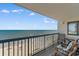 Balcony with ocean view, seating and table, offering a relaxing spot to enjoy the coastal scenery and fresh air at 201 S Ocean Blvd., North Myrtle Beach, SC 29582