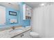 Bright blue bathroom with a granite countertop vanity, a linen cabinet, and shower-tub combination at 201 S Ocean Blvd., North Myrtle Beach, SC 29582