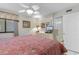 Cozy bedroom with a queen bed, a ceiling fan, and a cream-colored dresser with a TV at 201 S Ocean Blvd., North Myrtle Beach, SC 29582
