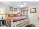 Comfortable bedroom with a queen bed, a ceiling fan, and charming coastal decor at 201 S Ocean Blvd., North Myrtle Beach, SC 29582