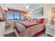 Bright bedroom features ocean views, a desk, and a comfortable bed with red accents at 201 S Ocean Blvd., North Myrtle Beach, SC 29582
