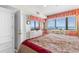 Well-lit bedroom boasts ocean views, white furniture, and a cozy floral comforter with red trim at 201 S Ocean Blvd., North Myrtle Beach, SC 29582