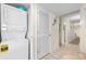 Hallway with stacked washer/dryer and a glimpse into other rooms with light tile flooring and neutral tones at 201 S Ocean Blvd., North Myrtle Beach, SC 29582