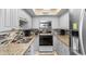 Efficient kitchen with white cabinets, granite countertops, and stainless steel appliances at 201 S Ocean Blvd., North Myrtle Beach, SC 29582