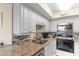 Well-equipped kitchen featuring white cabinets, mosaic backsplash, and stainless appliances at 201 S Ocean Blvd., North Myrtle Beach, SC 29582