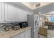 Bright kitchen with granite counters, stainless steel refrigerator, and adjoining dining area at 201 S Ocean Blvd., North Myrtle Beach, SC 29582