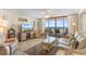 Bright living room with ocean views and access to balcony at 201 S Ocean Blvd., North Myrtle Beach, SC 29582