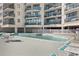 Community pool with comfortable lounge chairs and multiple balconies overlooking the water at 201 S Ocean Blvd., North Myrtle Beach, SC 29582