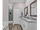 Bright bathroom featuring double sink vanity with white cabinets and a modern glass shower at 226 9Th Ave. S, North Myrtle Beach, SC 29582