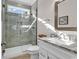 Bathroom featuring glass shower, gray tiled walls, white cabinets, and granite vanity at 226 9Th Ave. S, North Myrtle Beach, SC 29582