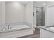 Bathroom featuring a soaking tub and a glass enclosed shower at 226 9Th Ave. S, North Myrtle Beach, SC 29582