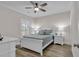 Comfortable bedroom showcasing a full-sized bed, ceiling fan, and window with shutters at 226 9Th Ave. S, North Myrtle Beach, SC 29582