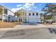 Two-story home with a two-car garage, charming balcony, well-maintained landscaping, and inviting curb appeal at 226 9Th Ave. S, North Myrtle Beach, SC 29582