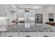 Modern kitchen features granite countertops, stainless steel appliances, and white cabinetry at 226 9Th Ave. S, North Myrtle Beach, SC 29582