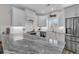 Modern kitchen features granite countertops, stainless steel appliances, and white cabinetry at 226 9Th Ave. S, North Myrtle Beach, SC 29582