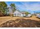 Backyard view with a screened porch, neat lawn, mature trees, and simple landscaping at 229 Duchess Ct., Myrtle Beach, SC 29588