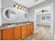 Bathroom features dual sinks, granite counters, framed circular mirrors, and modern lighting at 229 Duchess Ct., Myrtle Beach, SC 29588