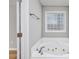 Bright bathroom showcases a white jacuzzi tub beneath a window at 229 Duchess Ct., Myrtle Beach, SC 29588