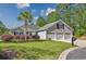 Charming single-Gathering home featuring a well-manicured lawn, mature landscaping, and a three-car garage at 229 Duchess Ct., Myrtle Beach, SC 29588