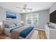 Staged main bedroom features a ceiling fan, a window, a bed, and wood-look flooring at 229 Duchess Ct., Myrtle Beach, SC 29588