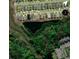 Aerial view of the community featuring home lots that border a pond and wooded areas at 232 Palm Cove Circle, Myrtle Beach, SC 29588