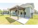 Backyard featuring a patio, a fan, a well maintained lawn and a black fence at 232 Palm Cove Circle, Myrtle Beach, SC 29588