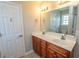 Bright bathroom with double sink vanity, wood cabinets and a large mirror at 232 Palm Cove Circle, Myrtle Beach, SC 29588