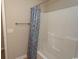 Bright bathroom with a blue patterned shower curtain and a white tiled shower and tub at 232 Palm Cove Circle, Myrtle Beach, SC 29588