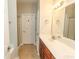 Bathroom with double sinks, wood vanity, large mirror, and walk-in shower at 232 Palm Cove Circle, Myrtle Beach, SC 29588