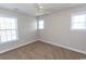 Bedroom features neutral walls, plush carpeting, a ceiling fan, and bright windows at 232 Palm Cove Circle, Myrtle Beach, SC 29588