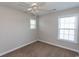 Bedroom with neutral walls, plush carpeting, a ceiling fan, and bright windows at 232 Palm Cove Circle, Myrtle Beach, SC 29588