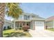 Charming two-story home features a landscaped yard, garage, and inviting entrance at 232 Palm Cove Circle, Myrtle Beach, SC 29588