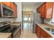 Kitchen featuring stainless appliances, granite counters, and wood cabinets open to dining area at 232 Palm Cove Circle, Myrtle Beach, SC 29588