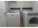 Laundry room featuring a white washing machine and dryer with overhead shelving at 232 Palm Cove Circle, Myrtle Beach, SC 29588