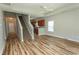 Open-concept living room with hardwood floors, staircase, and eat-in kitchen at 232 Palm Cove Circle, Myrtle Beach, SC 29588