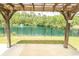 View of a tranquil pond with fountain from a covered patio with wooden beams at 232 Palm Cove Circle, Myrtle Beach, SC 29588