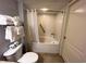 Bathroom featuring a bathtub-shower with safety grab bar and neatly folded towels for convenience and comfort at 2404 N Ocean Blvd. # 635, Myrtle Beach, SC 29577