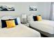 A modern bedroom with two queen beds, matching decorations, light-colored walls, and wood-look floors at 2404 N Ocean Blvd. # 635, Myrtle Beach, SC 29577