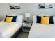 Bright bedroom with twin beds, white wooden headboards, and colorful accent pillows for a fresh, inviting space at 2404 N Ocean Blvd. # 635, Myrtle Beach, SC 29577