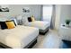 Bright bedroom with two queen beds, gray curtains, light-colored walls, modern decorations and wood-look floors at 2404 N Ocean Blvd. # 635, Myrtle Beach, SC 29577