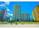 View of high-rise condo building with ocean views and beach access on a bright, sunny day with blue skies at 2404 N Ocean Blvd. # 635, Myrtle Beach, SC 29577